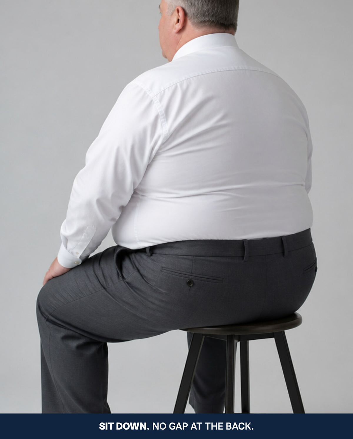 Seated from behind, the waistband still flat against the back with no gap